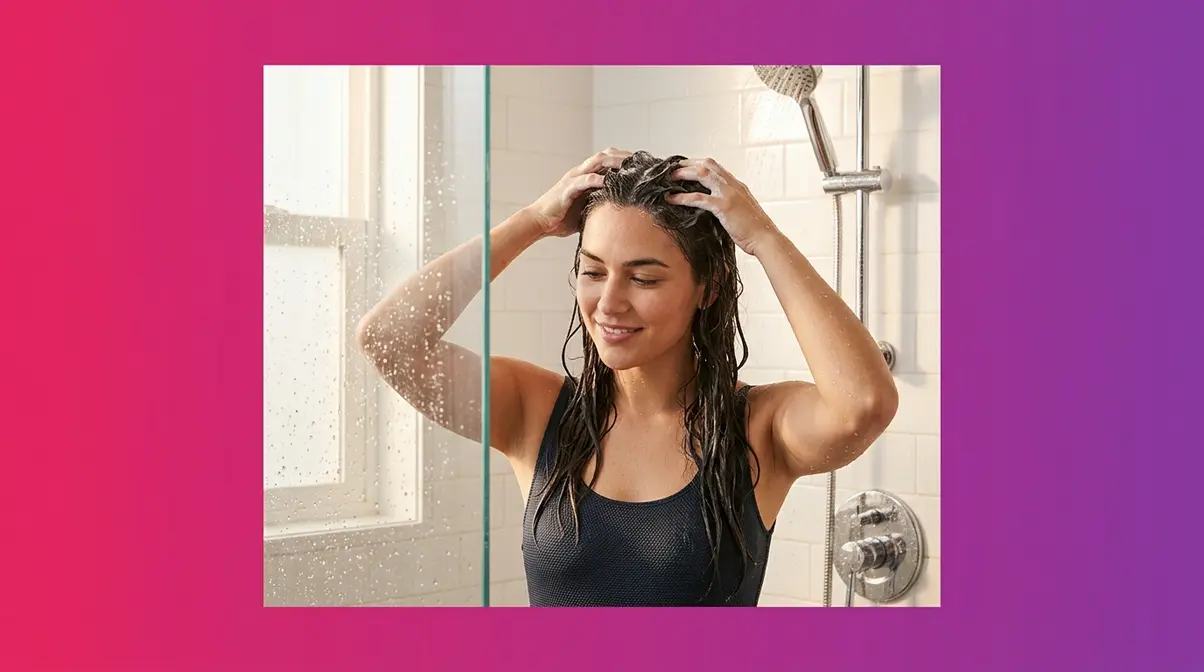 Woman washing wavy hair with correct scalp-only shampoo technique in shower