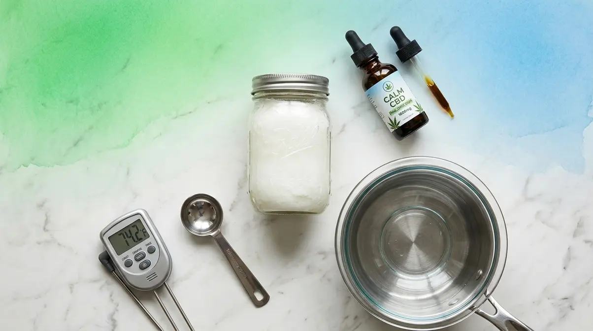 Ingredients and double boiler equipment for making CBD-infused coconut oil cooking base at home