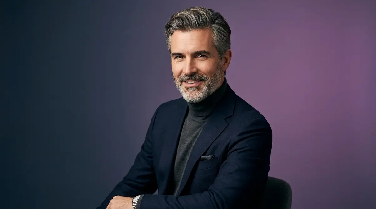 Man with well-groomed salt and pepper hair and coordinated beard showing distinguished style